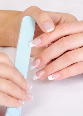 manicurist-doing-polishing-female-fingernails-with-french-manicure manicurist-doing-polishing-female-fingernails-with-french-manicure