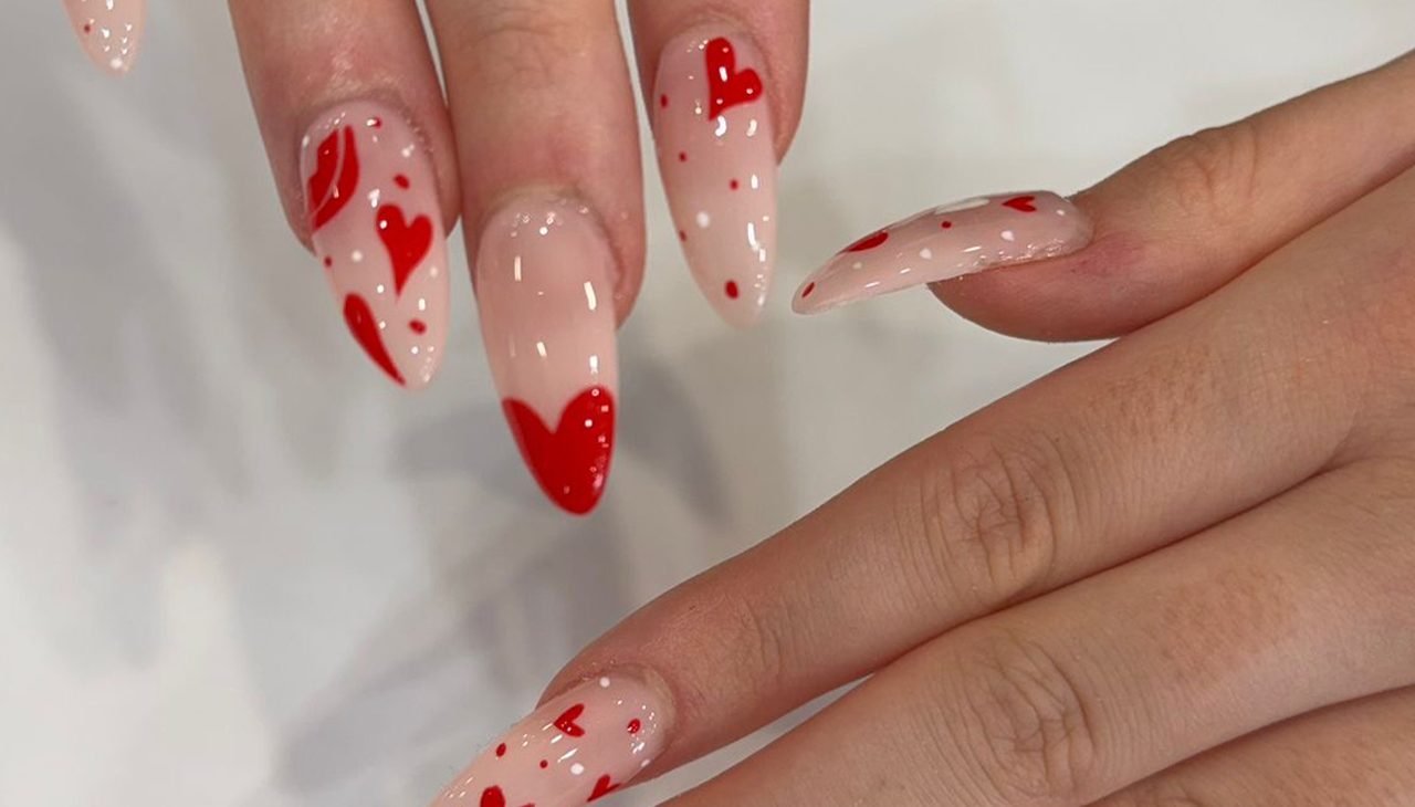 soft-gentle-photo-woman-hand-with-big-ring-red-manicure-hold-cute-little-pink-dried-flowers-white
